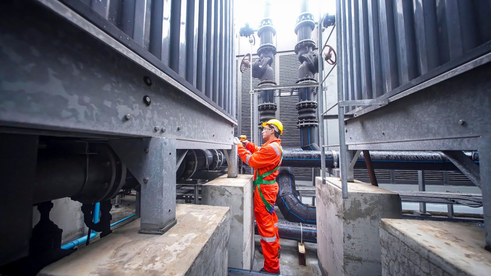 Engineering working in a facility wearing PPE
